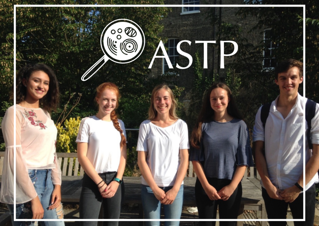 Five students standing outside smiling with the ASTP logo above and a white line border