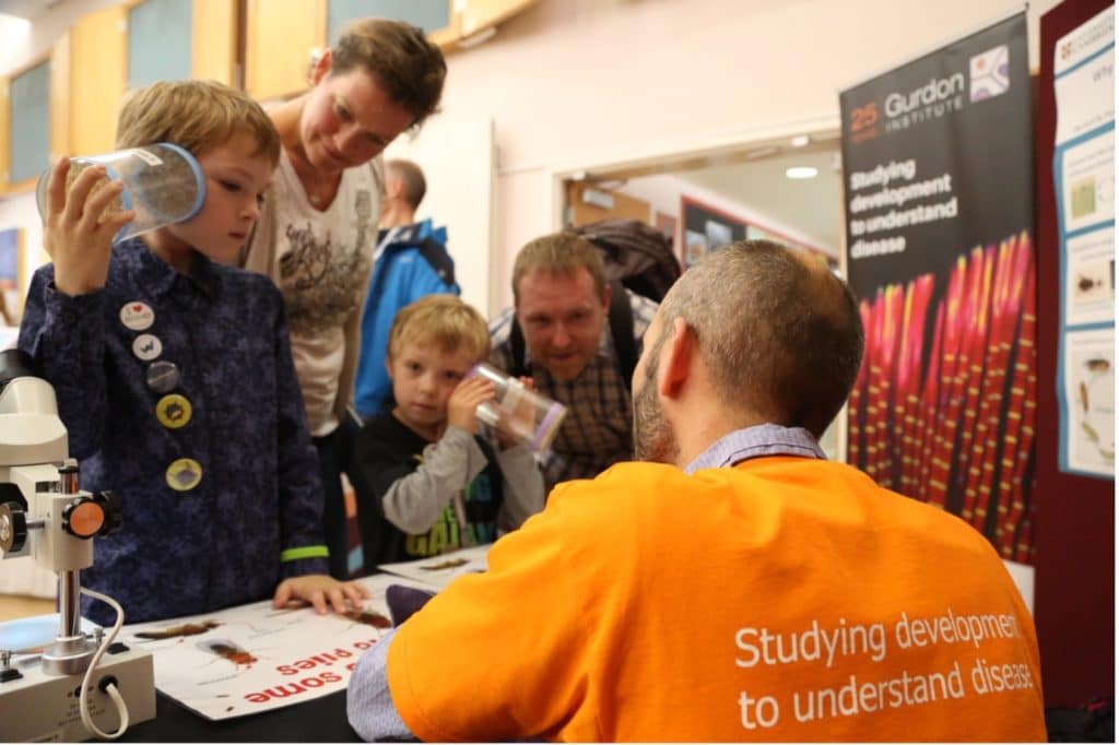 Scientist engaging with a family at a public event
