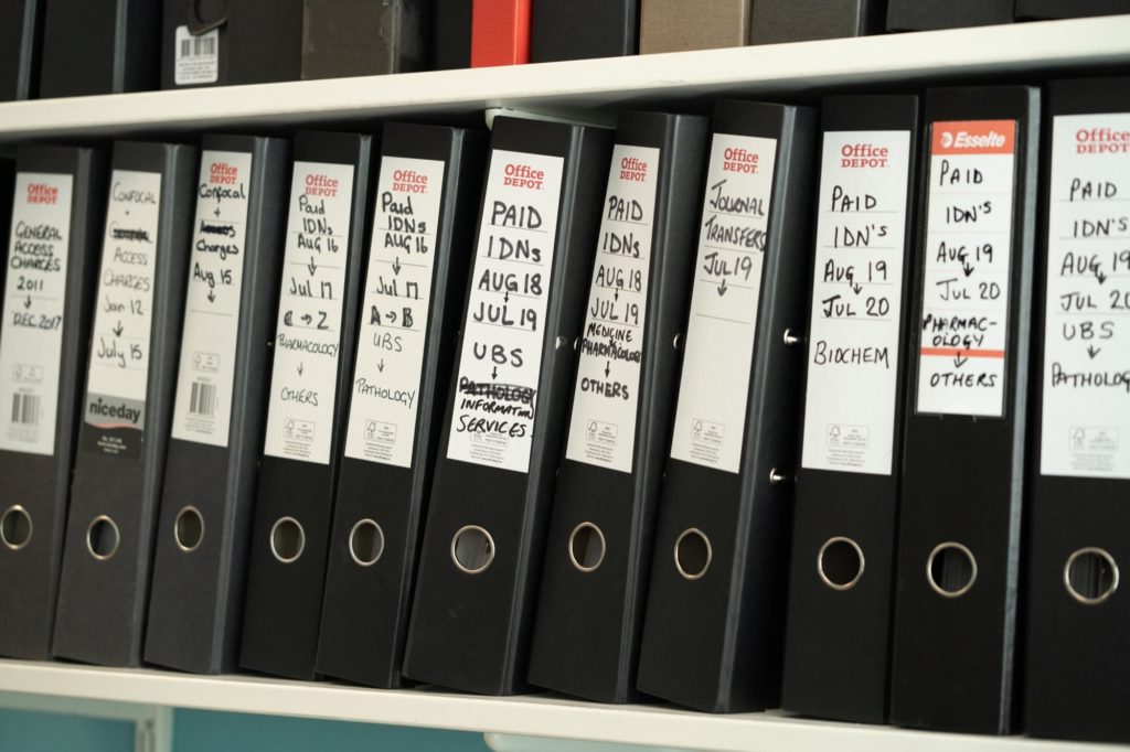 Photo of folders of invoices on shelf