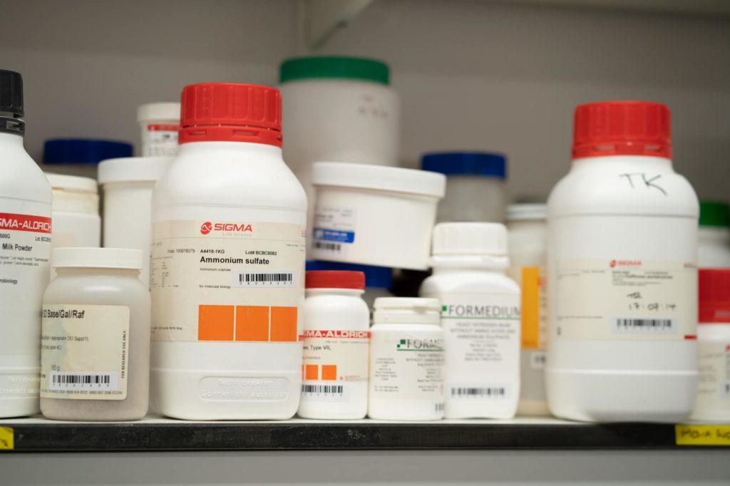 Chemicals on shelf in Kouzarides lab