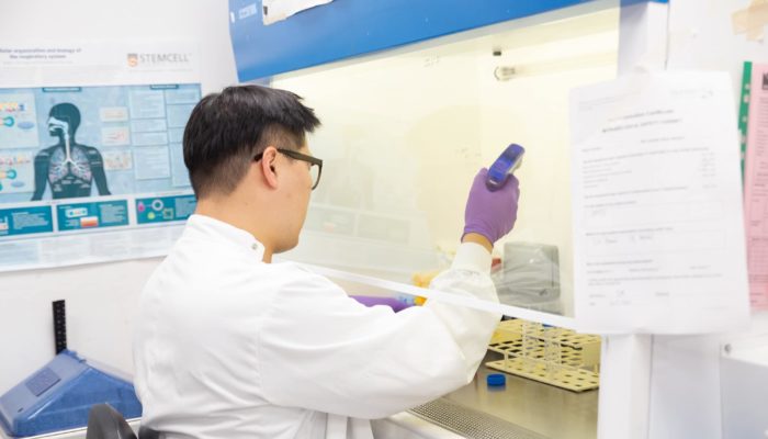 Kyungtae Lim in the Rawlins lab working at the tissue culture cabinet