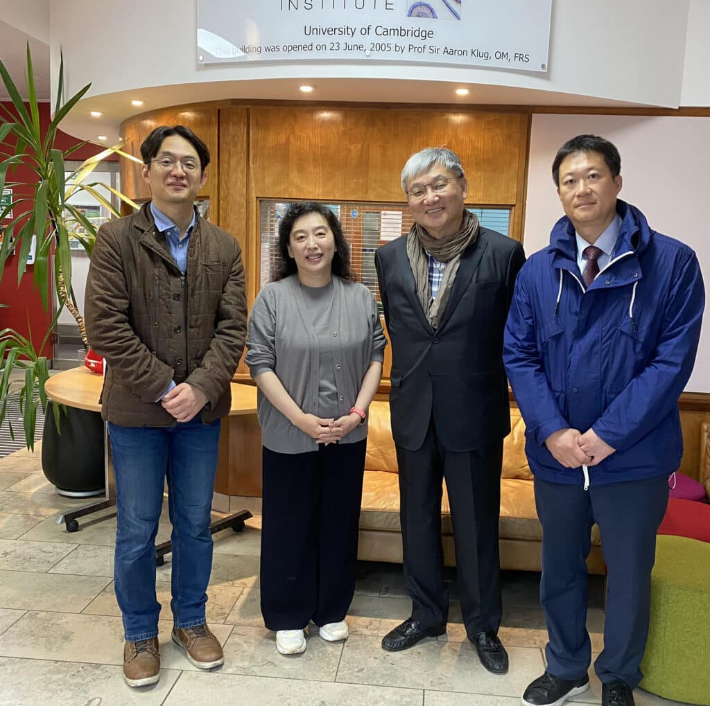 Three visitors from Korea pose in Reception with Seungmin Han from the Simons lab